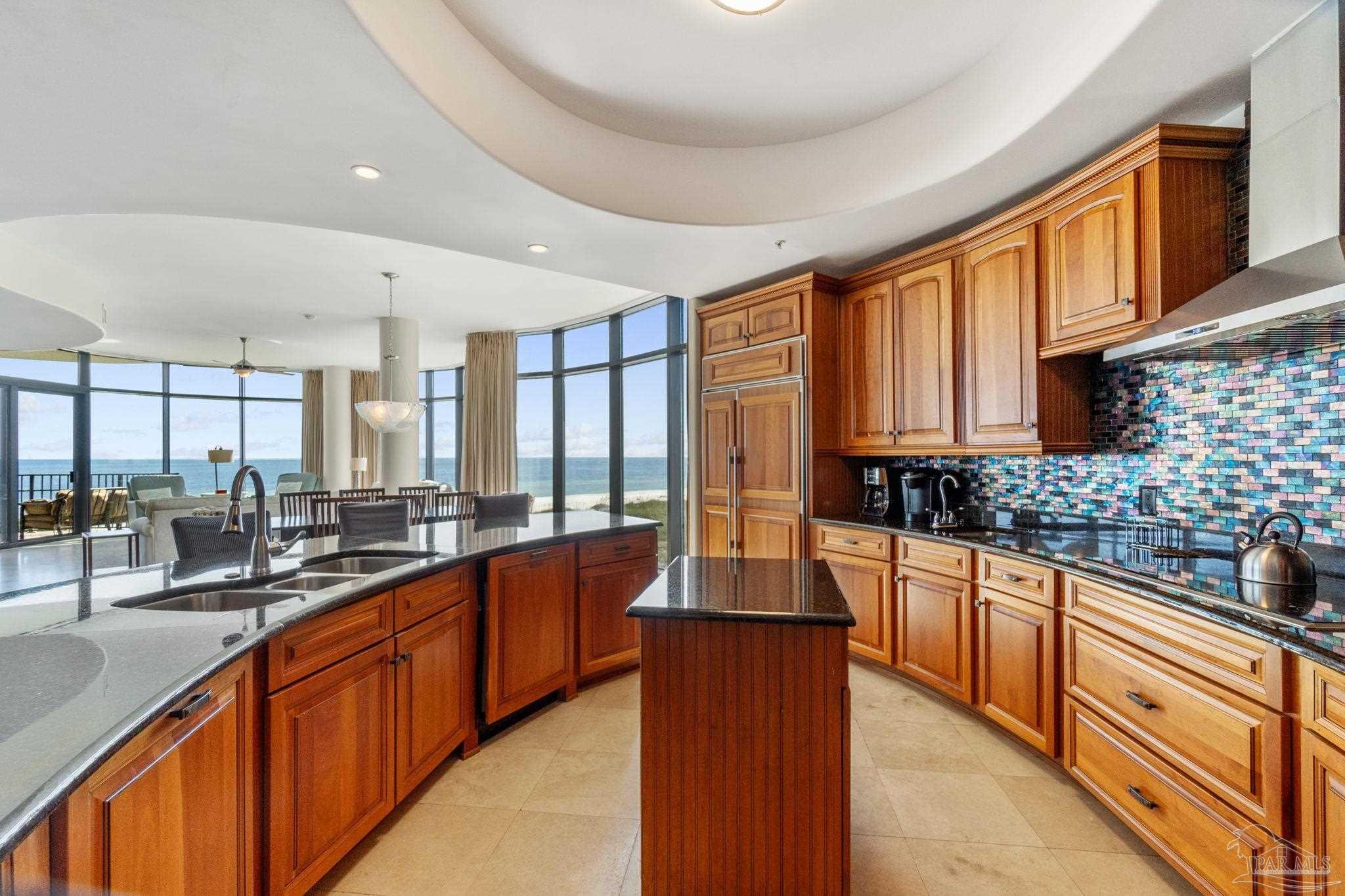 16551 Perdido Key Drive, Unit 202 Perdido Key, FL 32507 - Photo 16 of 54 a large kitchen with stainless steel appliances and large windows