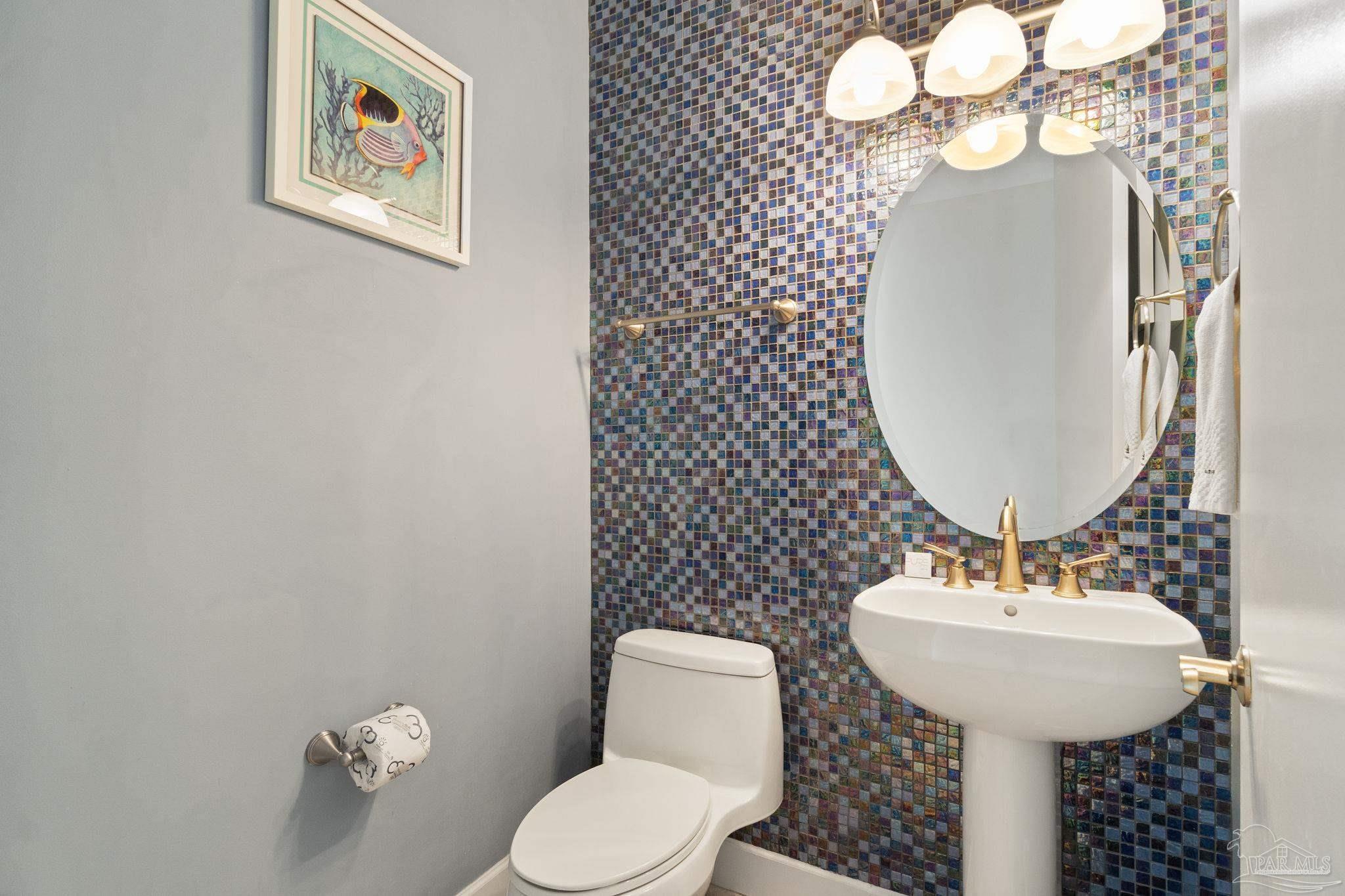 16551 Perdido Key Drive, Unit 202 Perdido Key, FL 32507 - Photo 20 of 54 a bathroom with a toilet a sink and mirror