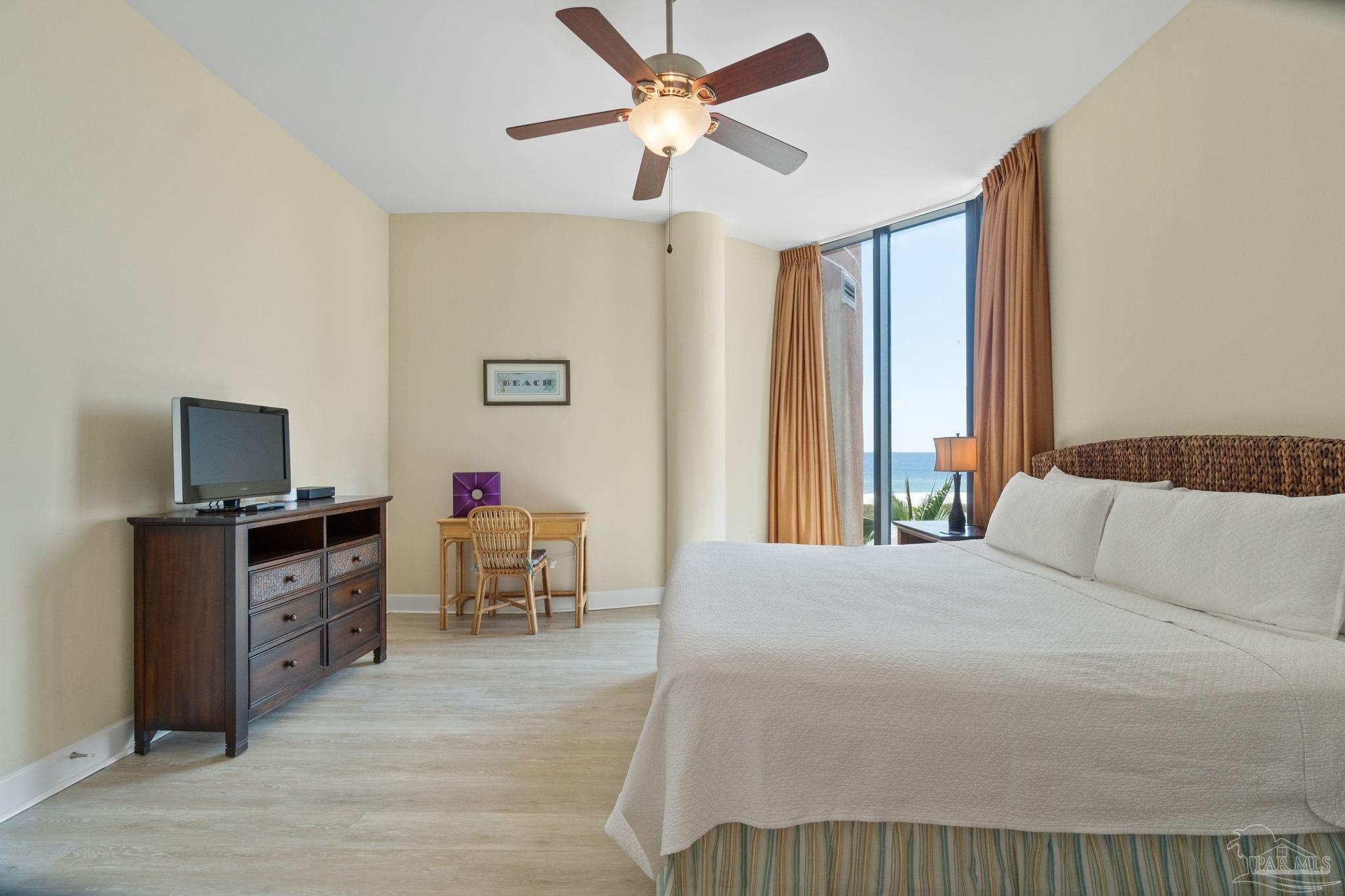 16551 Perdido Key Drive, Unit 202 Perdido Key, FL 32507 - Photo 29 of 54 a bedroom with a bed and a flat screen tv