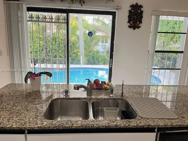 a kitchen with stainless steel appliances a stove a microwave and a refrigerator