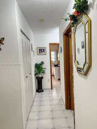 a bedroom with a bed mirror and window