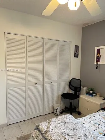 a view of a bedroom with a bed and a window
