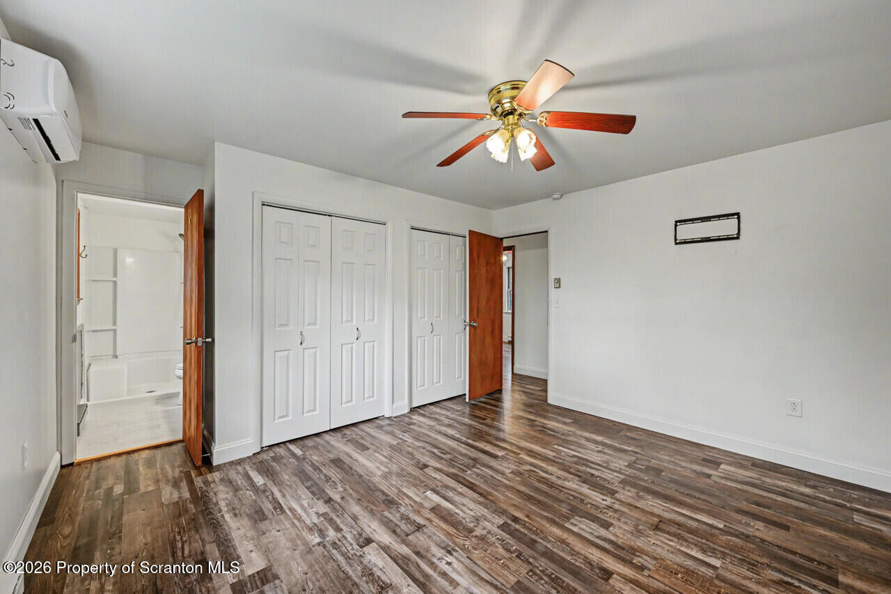 211 Buckingham Street Moscow, PA 18444 - Photo 44 of 83 a view of an empty room with wooden floor and a ceiling fan