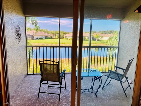 a view of a porch with a table and chairs