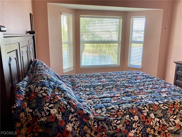 a bed sitting in a bedroom next to a window