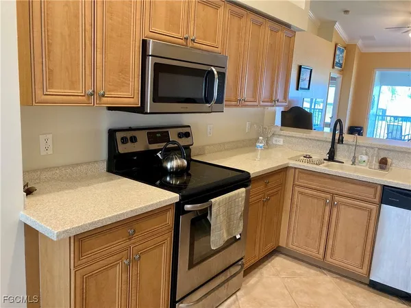 a kitchen with stainless steel appliances a stove microwave and sink