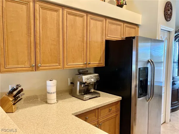 a kitchen with a refrigerator and cabinets