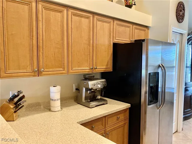 a kitchen with a refrigerator and cabinets