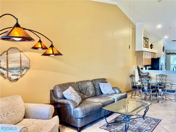 a living room with furniture and kitchen view