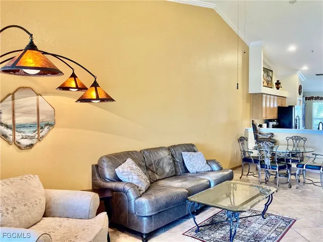 a living room with furniture and kitchen view