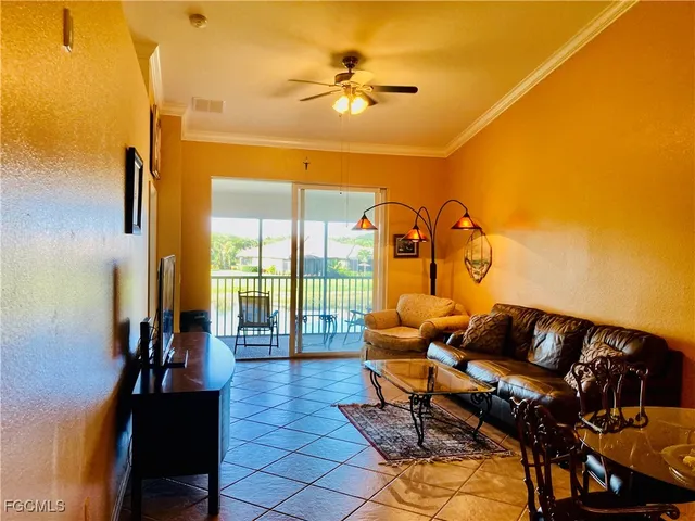 a living room with furniture and a floor to ceiling window