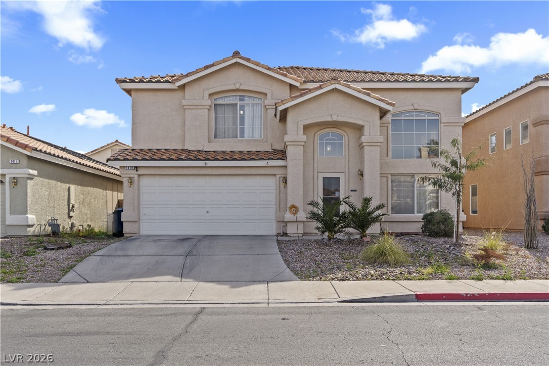 1419 Red Sunset Avenue Henderson, NV 89074 - Photo 1 of 35 Mediterranean / spanish-style home featuring stucco siding, concrete driveway, an attached garage, and a tiled roof