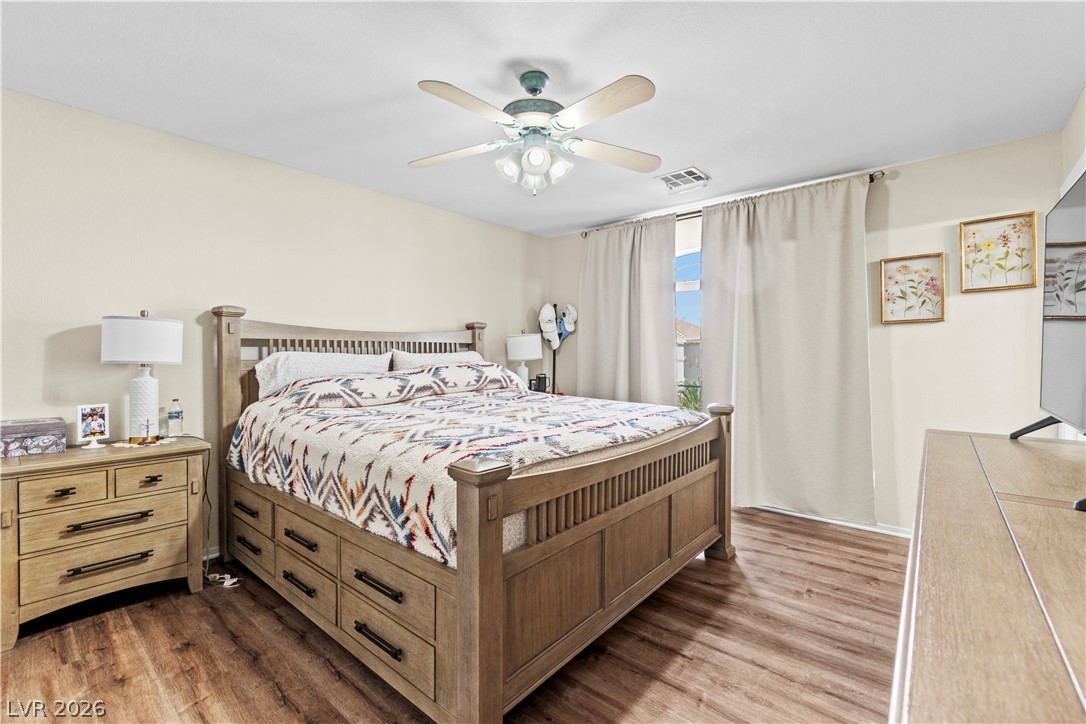1419 Red Sunset Avenue Henderson, NV 89074 - Photo 19 of 35 Bedroom with light wood finished floors and a ceiling fan