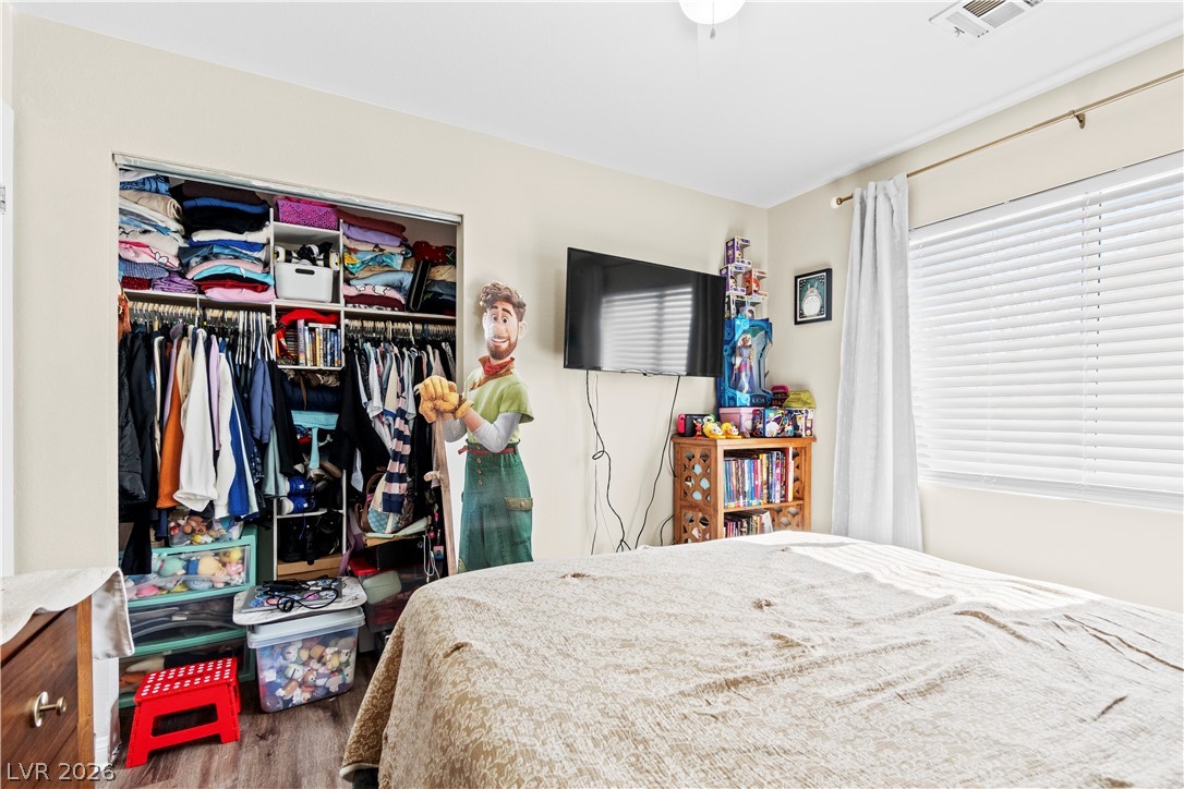 1419 Red Sunset Avenue Henderson, NV 89074 - Photo 27 of 35 Bedroom with wood finished floors and a closet
