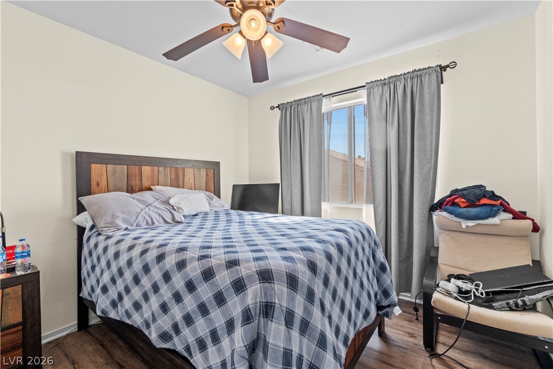1419 Red Sunset Avenue Henderson, NV 89074 - Photo 28 of 35 Bedroom with dark wood-style flooring and a ceiling fan