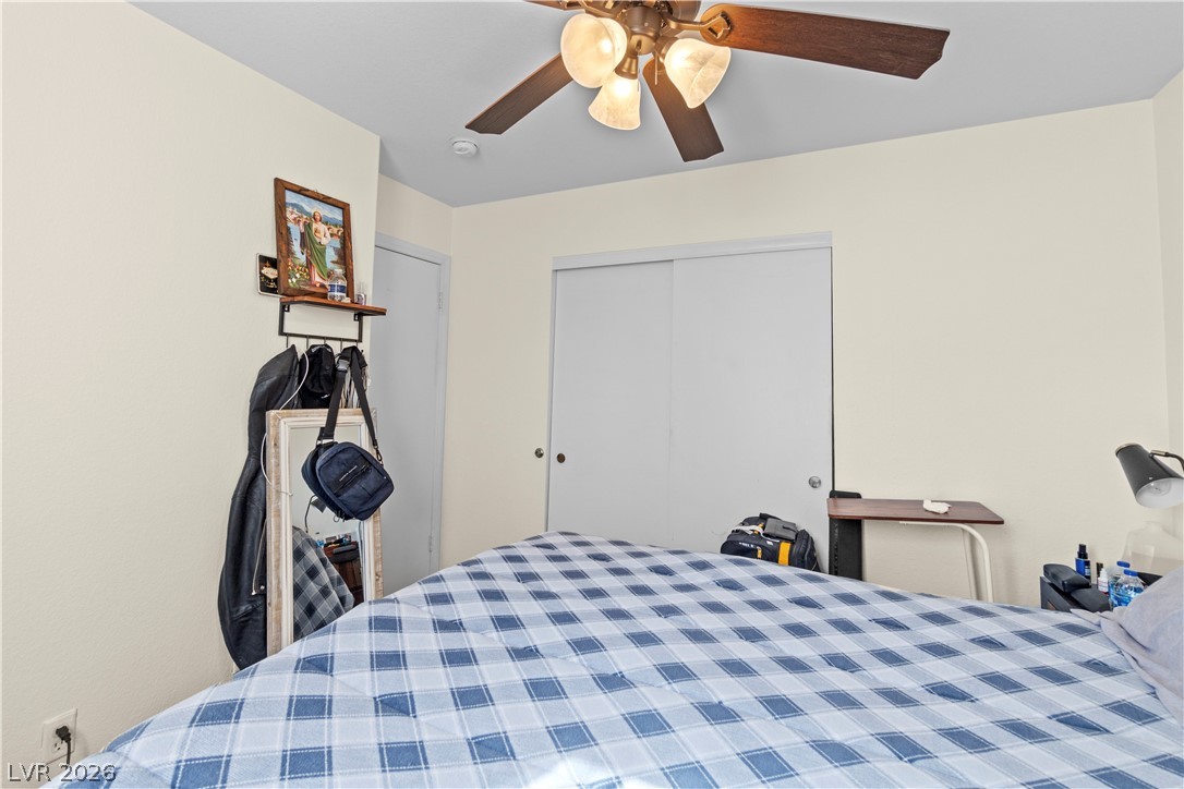 1419 Red Sunset Avenue Henderson, NV 89074 - Photo 30 of 35 Bedroom featuring a ceiling fan and a closet