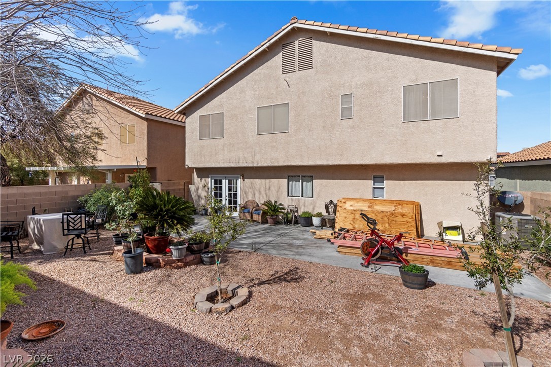 1419 Red Sunset Avenue Henderson, NV 89074 - Photo 34 of 35 Rear view of house with a patio and stucco siding