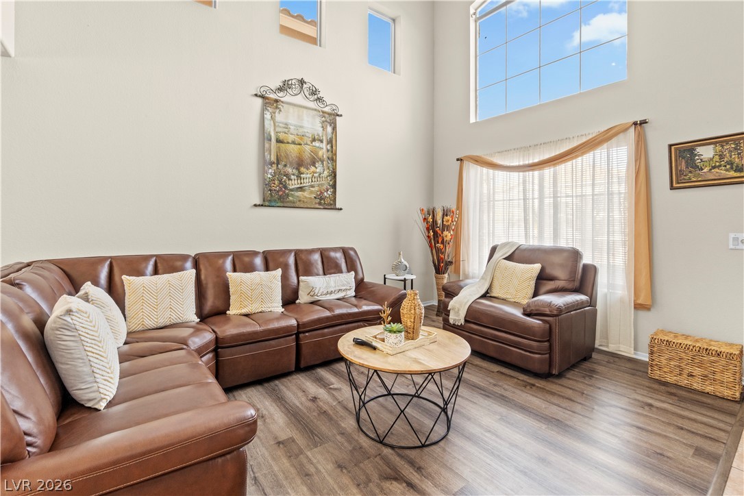 1419 Red Sunset Avenue Henderson, NV 89074 - Photo 5 of 35 Living area with a high ceiling and wood finished floors
