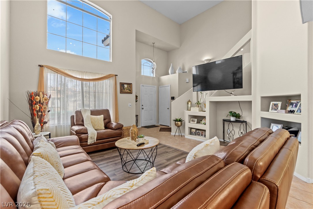 1419 Red Sunset Avenue Henderson, NV 89074 - Photo 7 of 35 Tiled living room with a high ceiling and built in features
