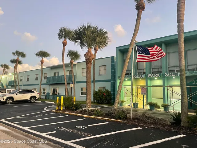a view of a street with cars parked