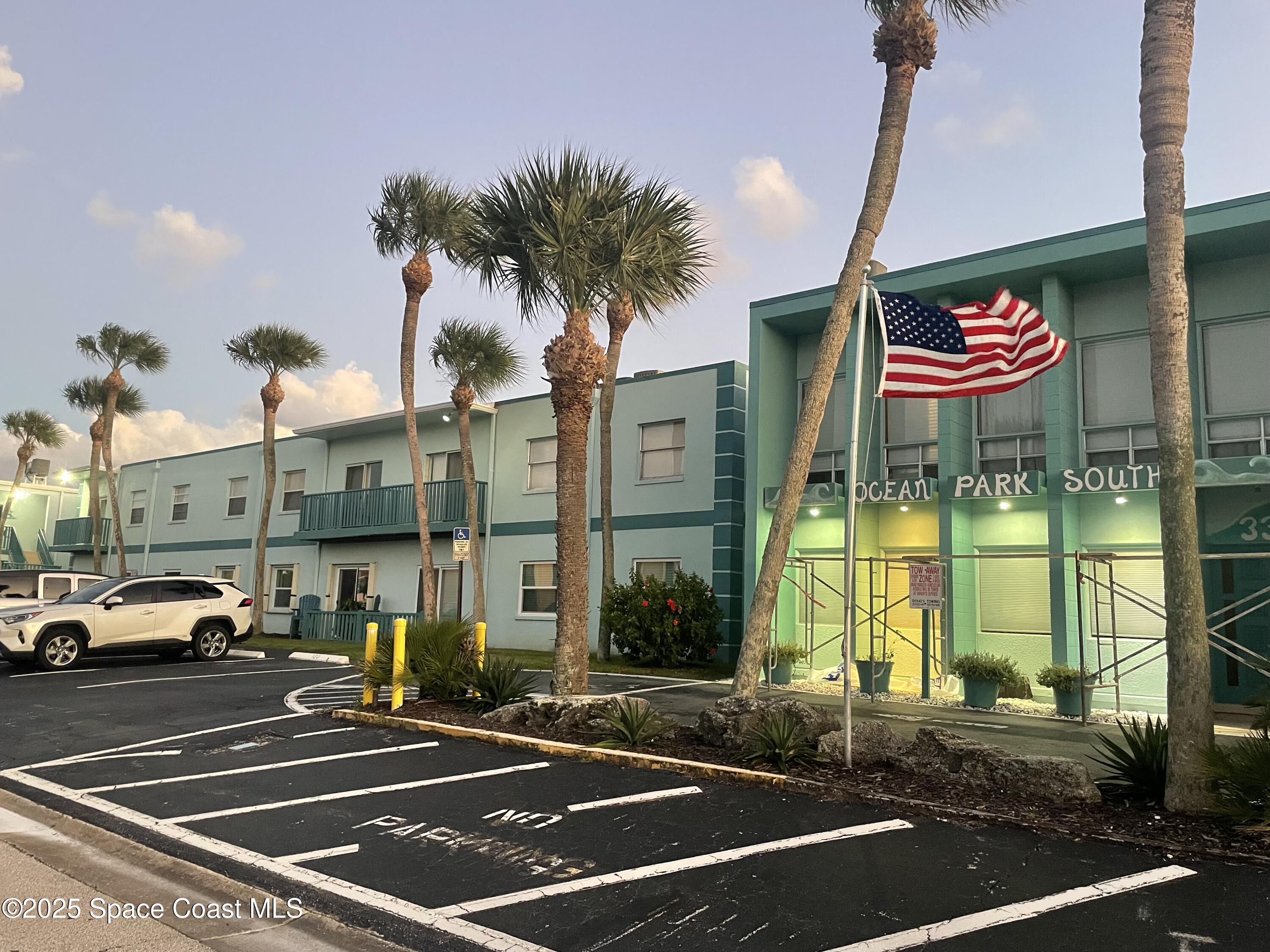 a view of a street with cars parked