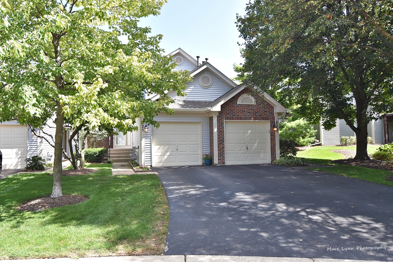 625 Cobblestone Court Elgin, IL 60120 - Photo 1 of 15 a front view of a house with a garden and trees