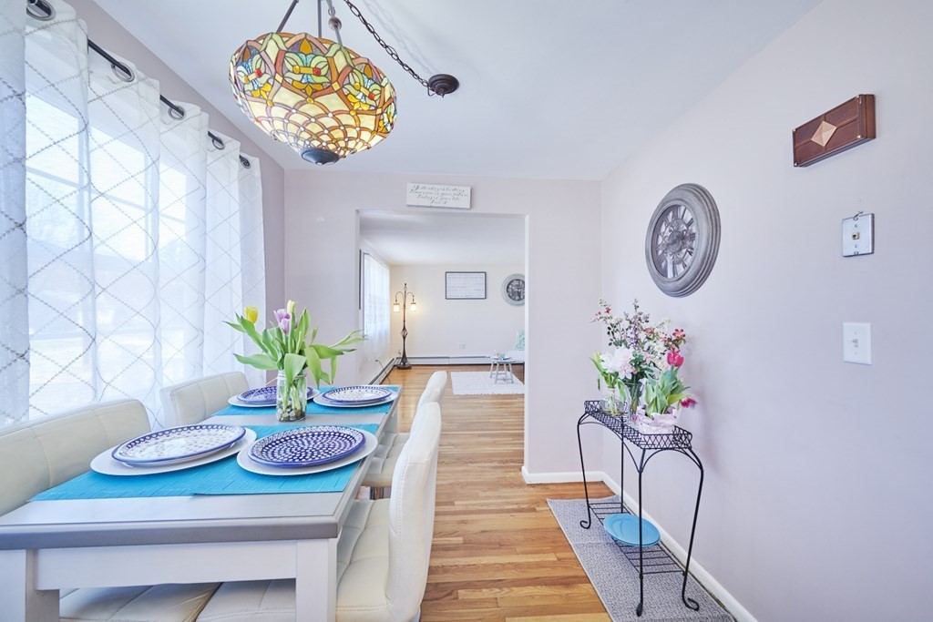 20 Carson Road Woburn, MA 01801 - Photo 18 of 38 a dining room with furniture and a potted plant