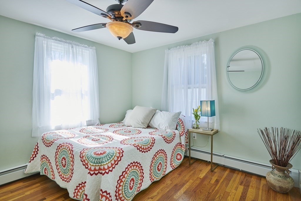 20 Carson Road Woburn, MA 01801 - Photo 21 of 38 a bedroom with a bed and a chandelier