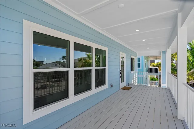 a kitchen with stainless steel appliances white cabinets and wooden floor