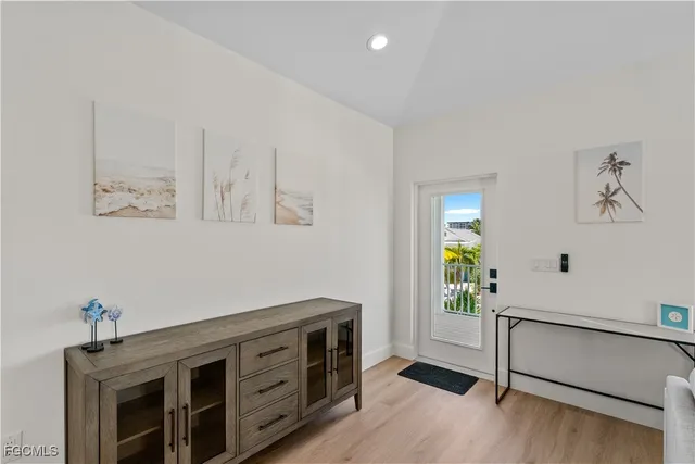 a living room with furniture and kitchen view