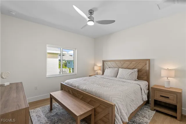 a bedroom with a bed and a ceiling fan