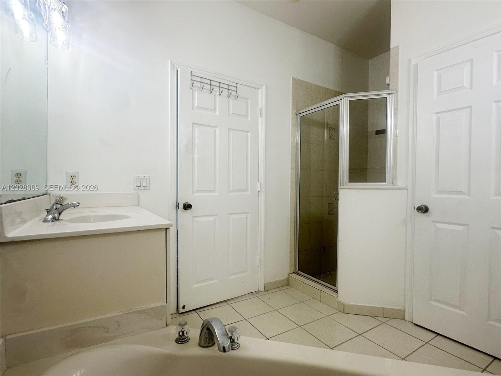 662 Northeast 21st Terrace Homestead, FL 33033 - Photo 17 of 34 a bathroom with a sink and a mirror