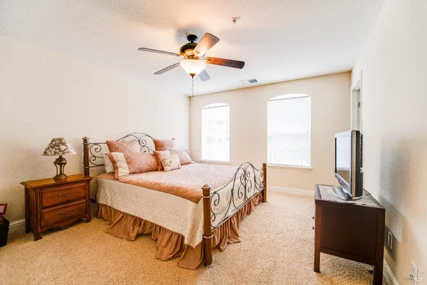 a bedroom with a bed and a chandelier