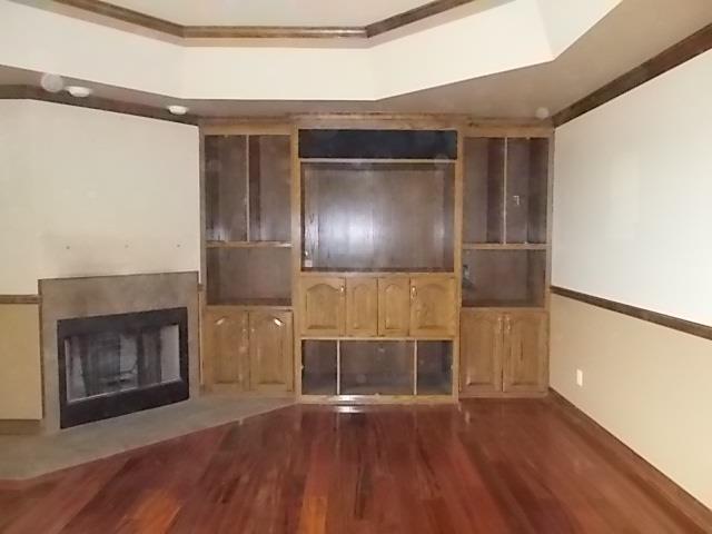 7621 South Harpeth Road Primm Springs, TN 38476 - Photo 3 of 20 a view of empty room with wooden floor and fireplace