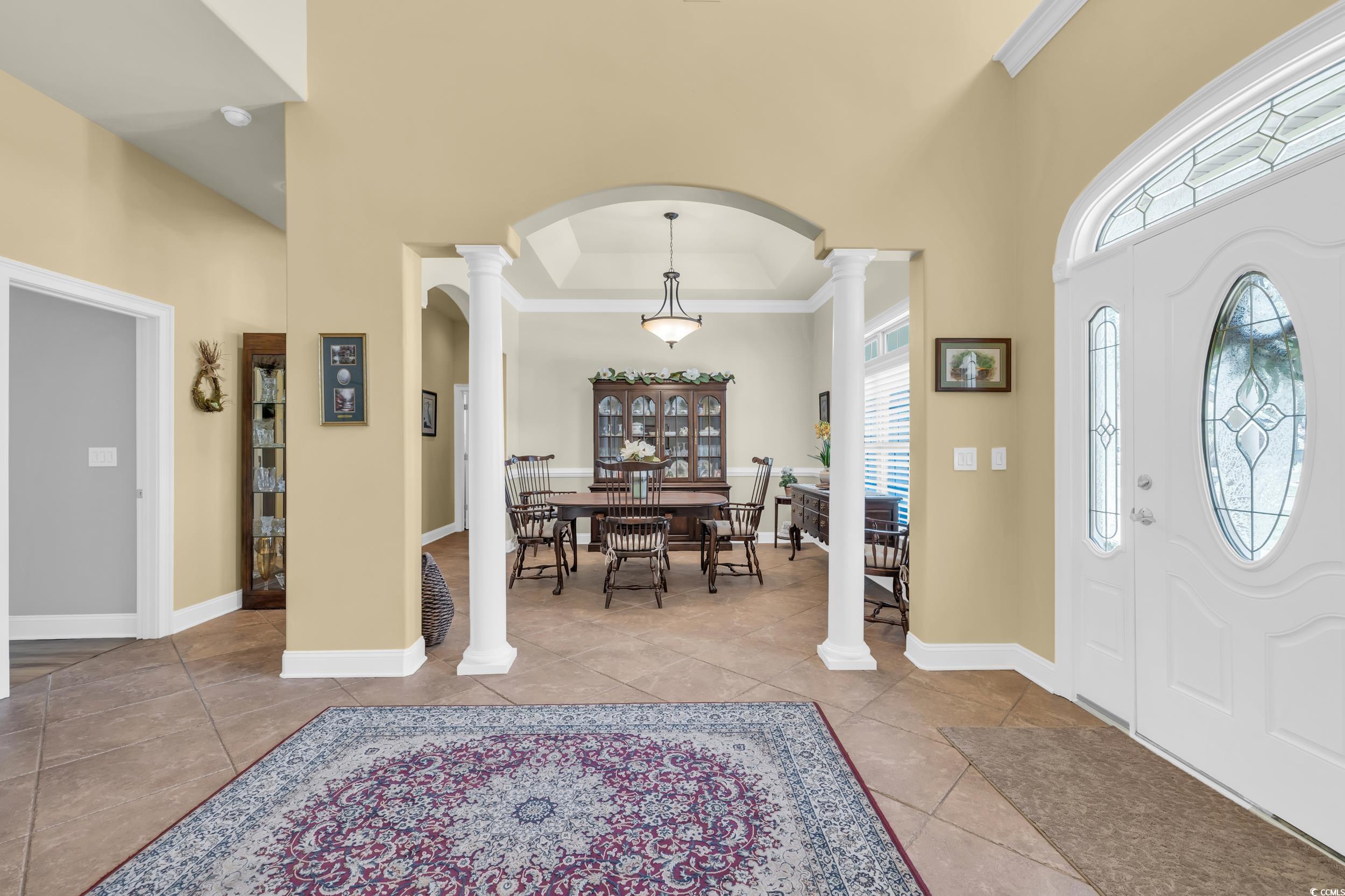 4254 Congressional Drive Myrtle Beach, SC 29579 - Photo 11 of 40 Foyer with ornate columns, a towering ceiling, tile flooring, and arched doorways