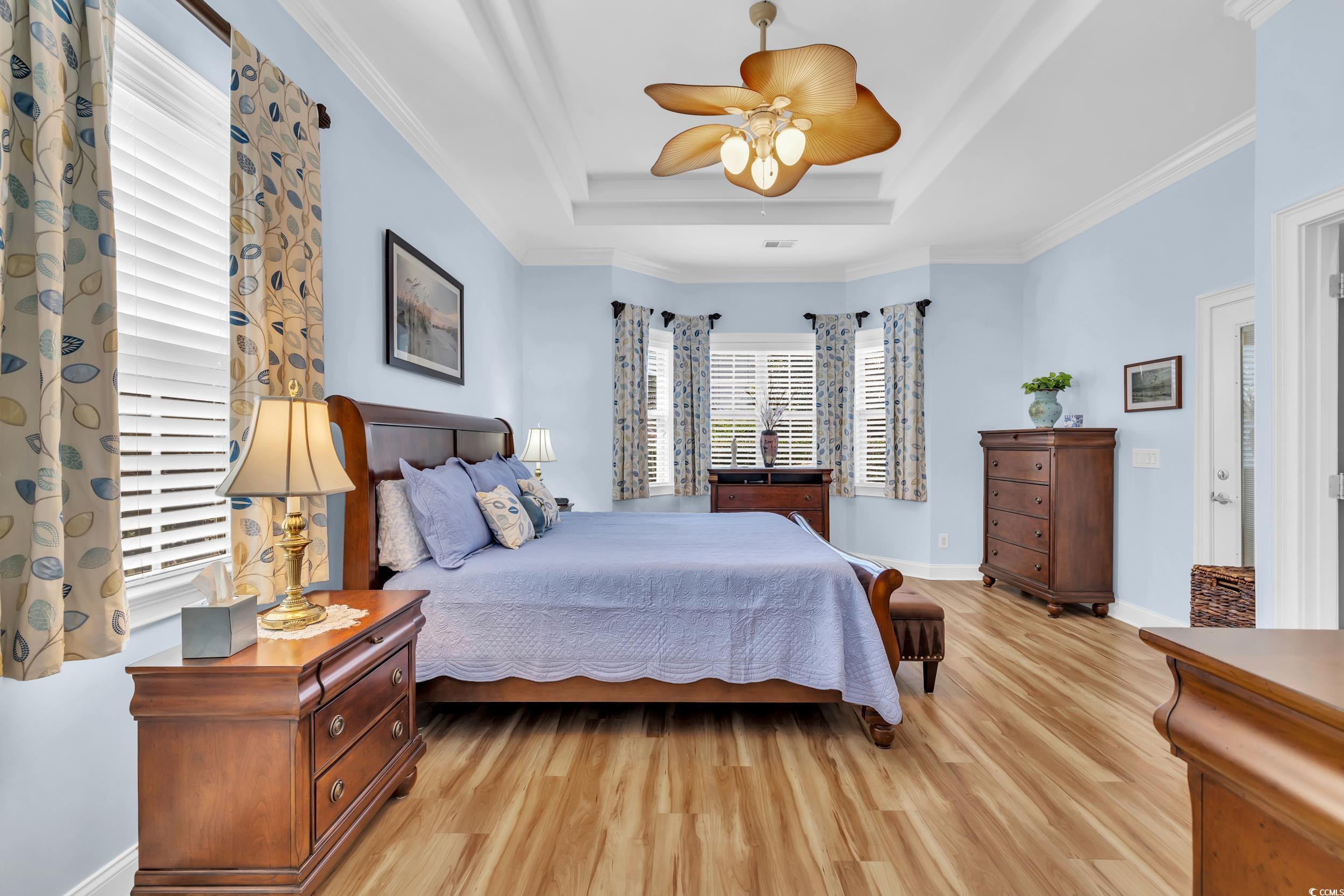 4254 Congressional Drive Myrtle Beach, SC 29579 - Photo 20 of 40 Bedroom with crown molding, LVP floors, a double tray ceiling, and ceiling fan