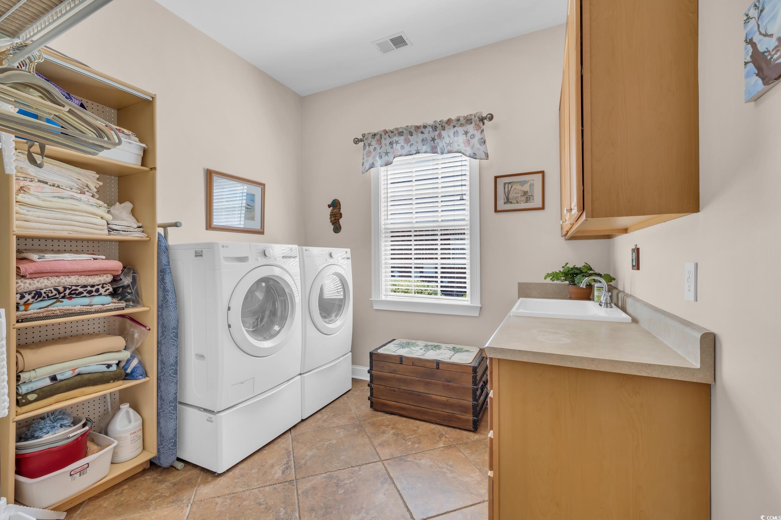 4254 Congressional Drive Myrtle Beach, SC 29579 - Photo 27 of 40 Laundry area with tile floors, washing machine and dryer, and cabinet space
