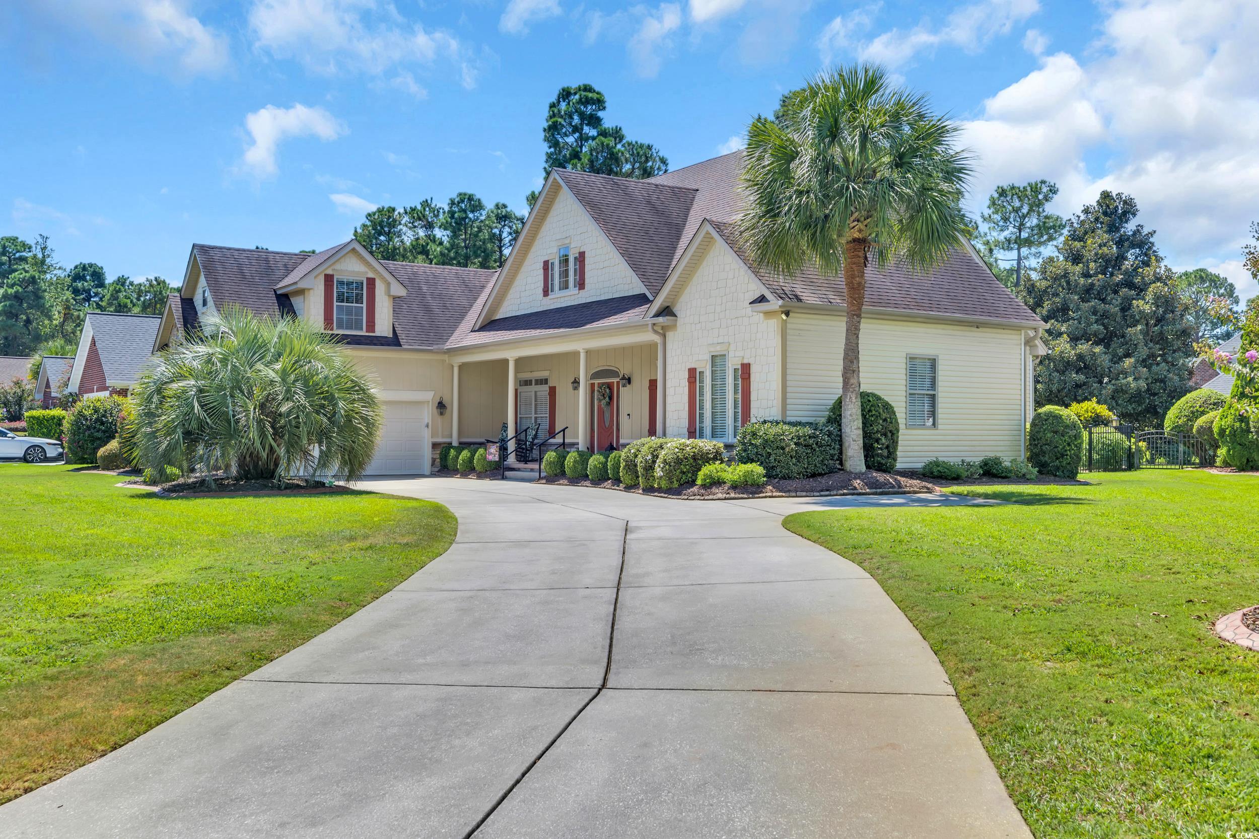 4254 Congressional Drive Myrtle Beach, SC 29579 - Photo 7 of 40 View of front facade with a front lawn, a porch, a garage, a shingled roof, and driveway