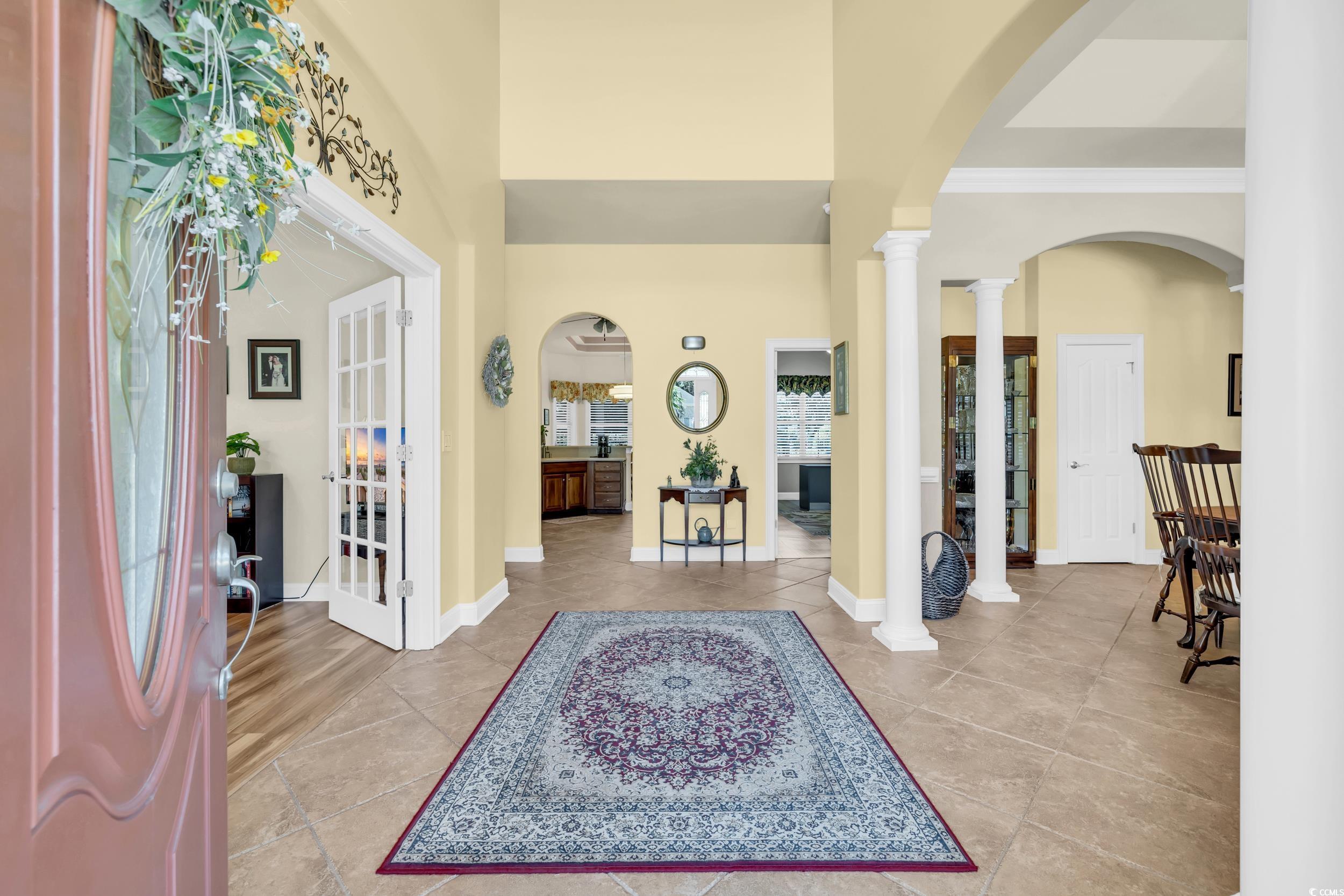 4254 Congressional Drive Myrtle Beach, SC 29579 - Photo 10 of 40 Foyer with arched doorways, 20' high ceiling, ornate columns, and tile floors