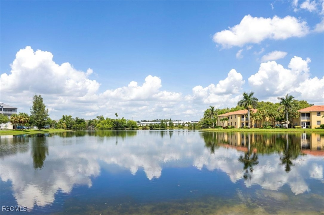 4336 Bellasol Circle, Unit 2911 Fort Myers, FL 33916 - Photo 1 of 45 a view of a lake with houses in back