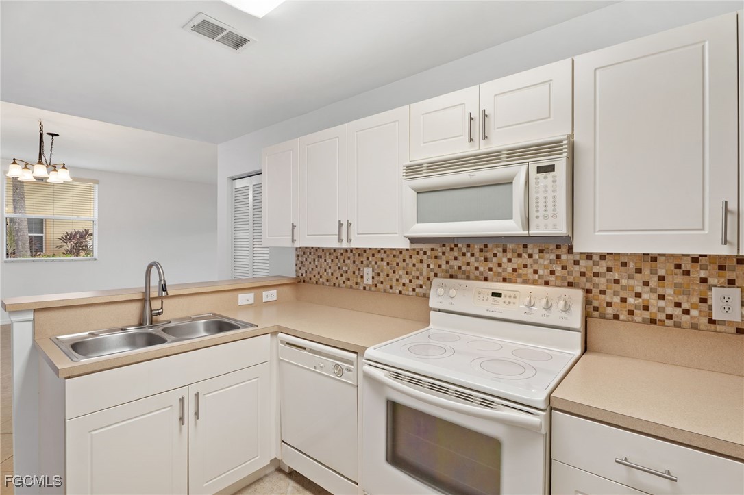 4336 Bellasol Circle, Unit 2911 Fort Myers, FL 33916 - Photo 19 of 45 a kitchen with appliances cabinets and a sink
