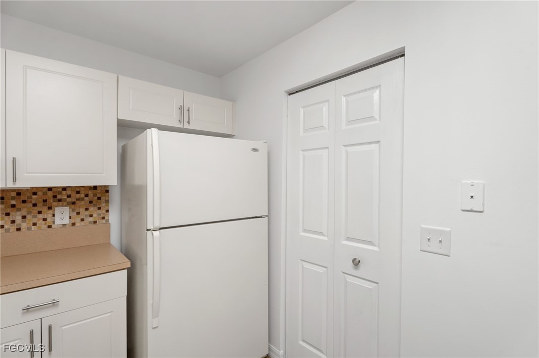 4336 Bellasol Circle, Unit 2911 Fort Myers, FL 33916 - Photo 20 of 45 a white refrigerator freezer and a stove sitting inside of a kitchen