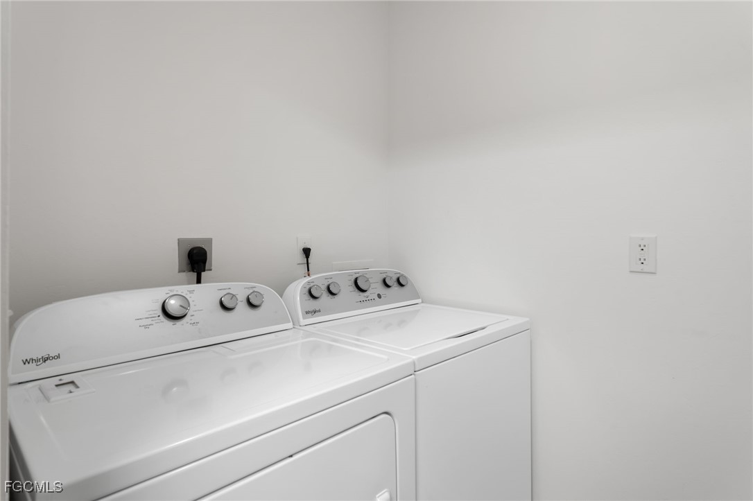 4336 Bellasol Circle, Unit 2911 Fort Myers, FL 33916 - Photo 21 of 45 a utility room with dryer and washer