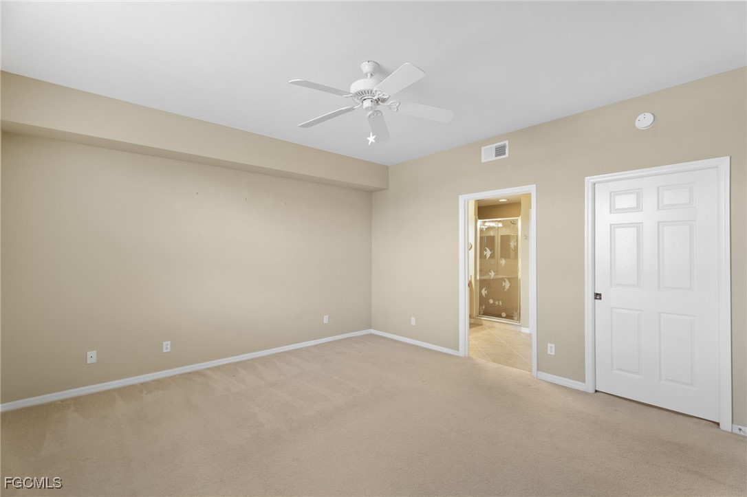 4336 Bellasol Circle, Unit 2911 Fort Myers, FL 33916 - Photo 25 of 45 an empty room with a ceiling fan and a window