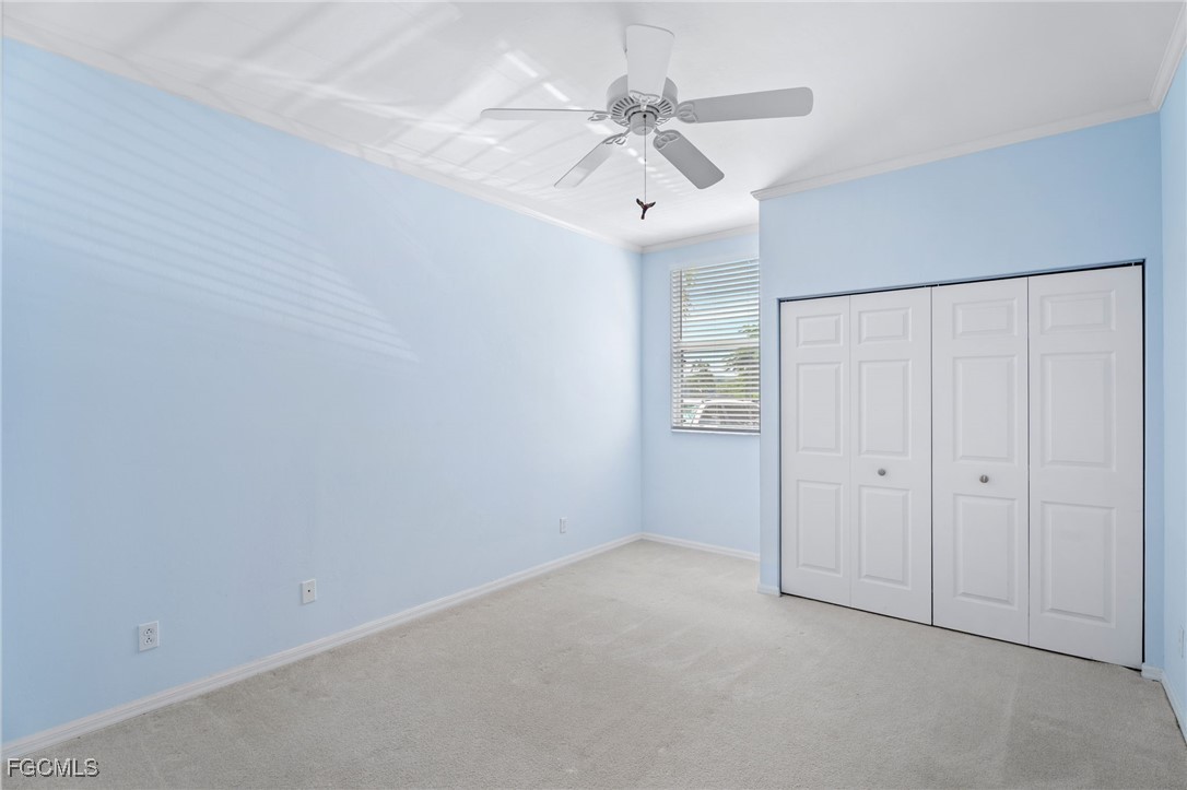4336 Bellasol Circle, Unit 2911 Fort Myers, FL 33916 - Photo 29 of 45 an empty room with a ceiling fan and a window