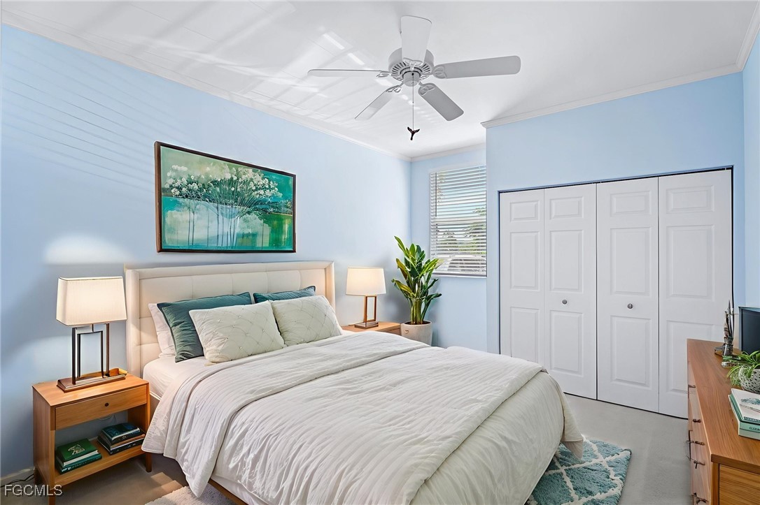 4336 Bellasol Circle, Unit 2911 Fort Myers, FL 33916 - Photo 30 of 45 a bedroom with a bed and a chandelier