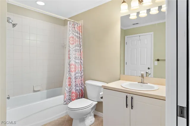 a bathroom with a sink a toilet a mirror a vanity and bathtub