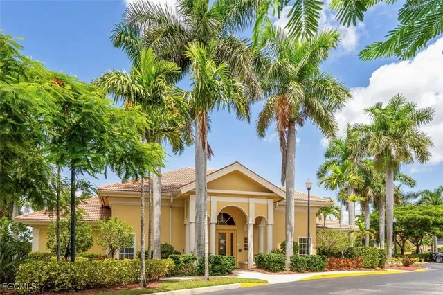 a front view of a house with a yard and potted plants