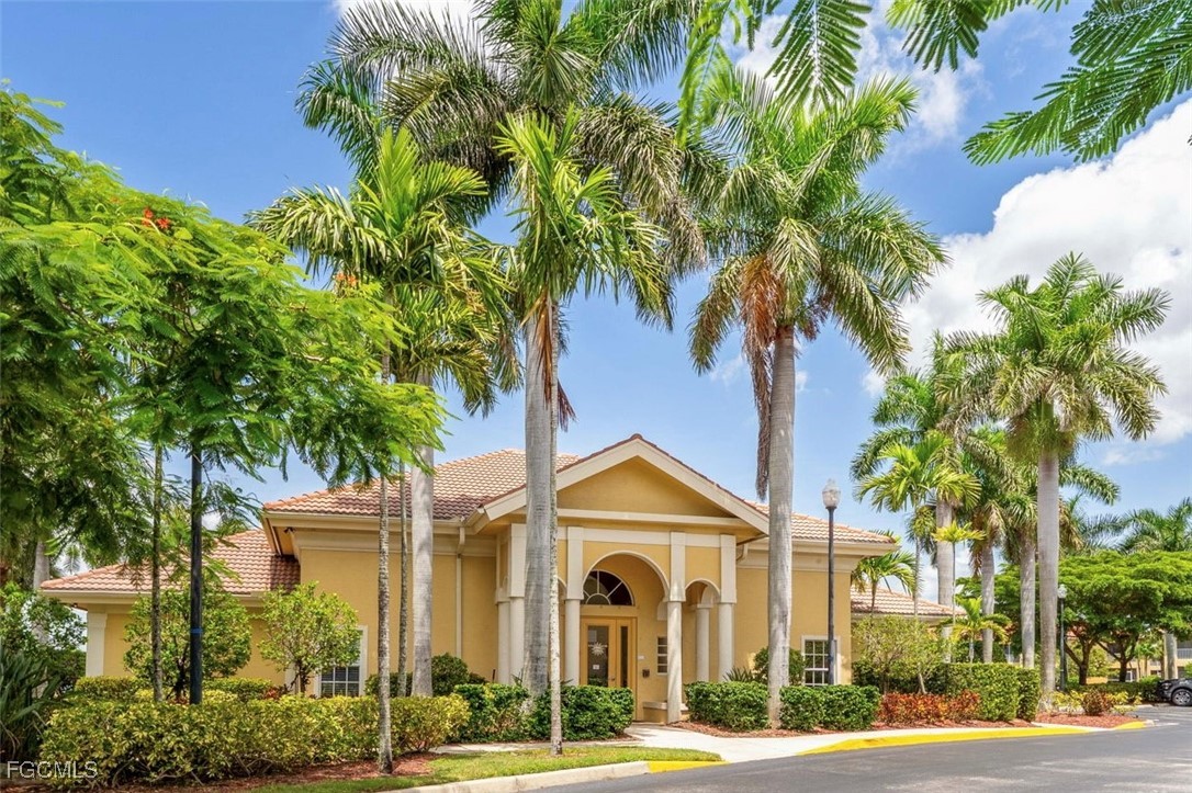 4336 Bellasol Circle, Unit 2911 Fort Myers, FL 33916 - Photo 39 of 45 a front view of a house with a yard and potted plants