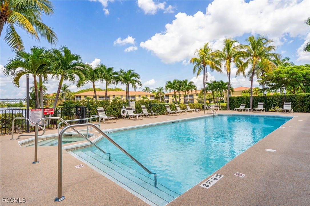 4336 Bellasol Circle, Unit 2911 Fort Myers, FL 33916 - Photo 42 of 45 a view of swimming pool with outdoor seating and house in the background